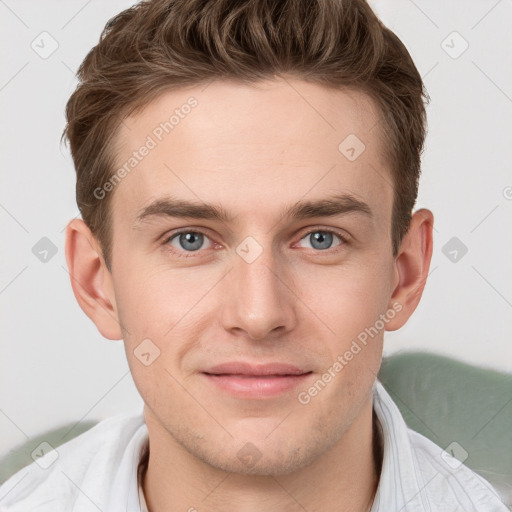 Joyful white young-adult male with short  brown hair and grey eyes