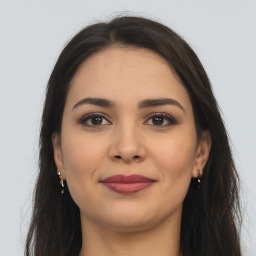 Joyful latino young-adult female with long  brown hair and brown eyes