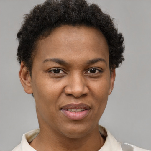 Joyful black young-adult female with short  brown hair and brown eyes