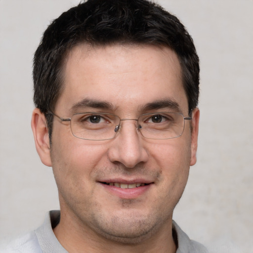 Joyful white adult male with short  brown hair and brown eyes