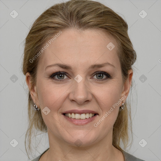 Joyful white adult female with medium  brown hair and grey eyes