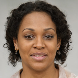 Joyful black adult female with medium  brown hair and brown eyes