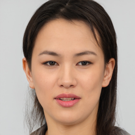 Joyful asian young-adult female with long  brown hair and brown eyes