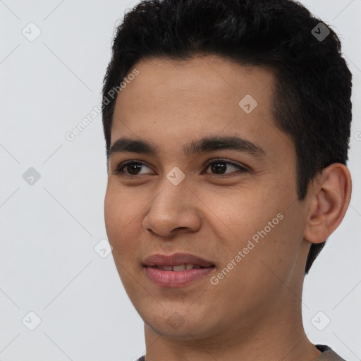 Joyful latino young-adult male with short  black hair and brown eyes