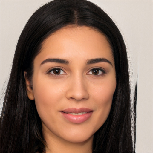 Joyful latino young-adult female with long  brown hair and brown eyes