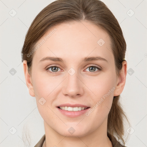 Joyful white young-adult female with medium  brown hair and grey eyes