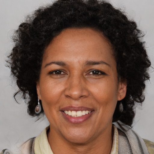 Joyful black adult female with short  brown hair and brown eyes