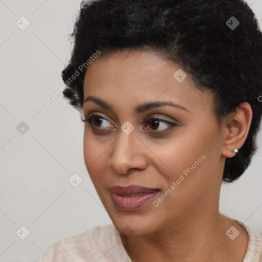 Joyful black young-adult female with short  black hair and brown eyes