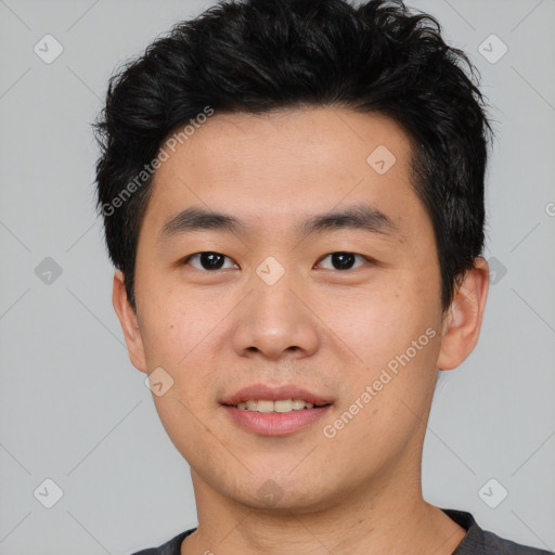 Joyful asian young-adult male with short  black hair and brown eyes