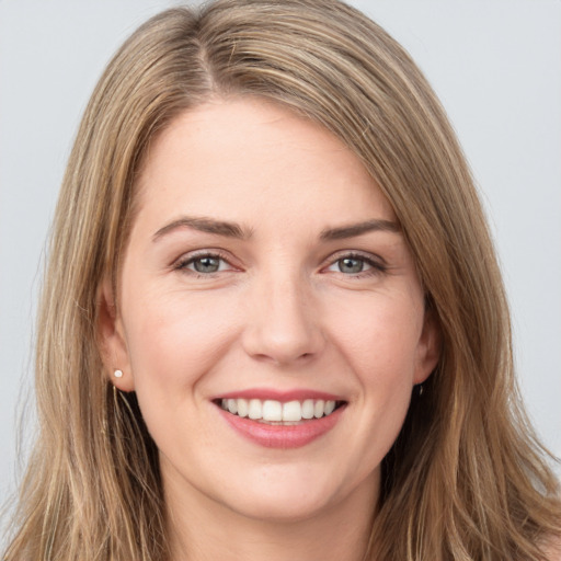 Joyful white young-adult female with long  brown hair and grey eyes