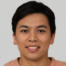 Joyful asian young-adult male with short  black hair and brown eyes