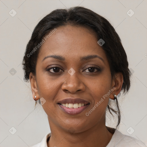 Joyful black adult female with medium  brown hair and brown eyes