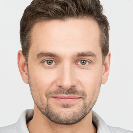 Joyful white young-adult male with short  brown hair and brown eyes