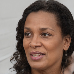 Joyful black adult female with medium  brown hair and brown eyes