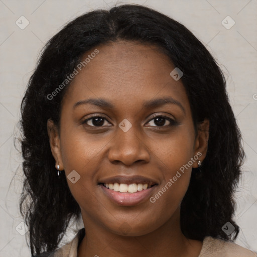 Joyful black young-adult female with long  brown hair and brown eyes