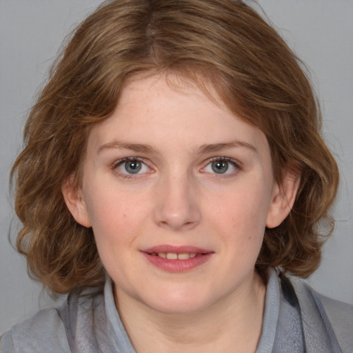 Joyful white young-adult female with medium  brown hair and blue eyes