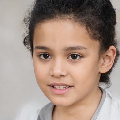 Joyful white child female with short  brown hair and brown eyes