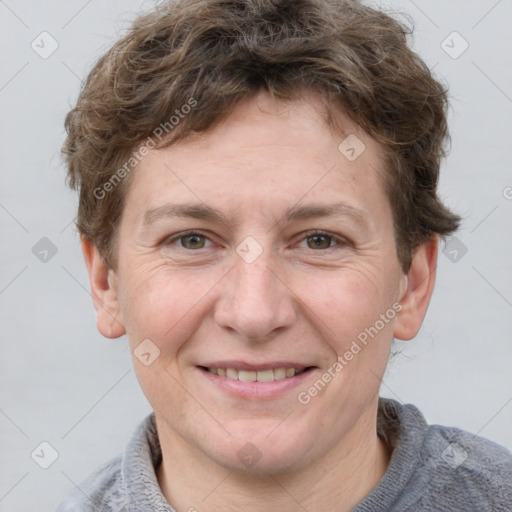 Joyful white adult male with short  brown hair and grey eyes