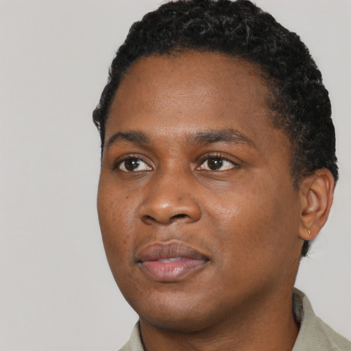 Joyful black young-adult male with short  brown hair and brown eyes