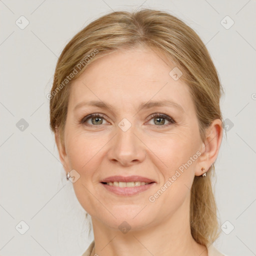 Joyful white adult female with medium  brown hair and grey eyes