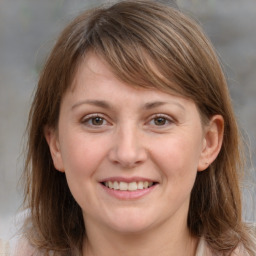 Joyful white adult female with medium  brown hair and grey eyes