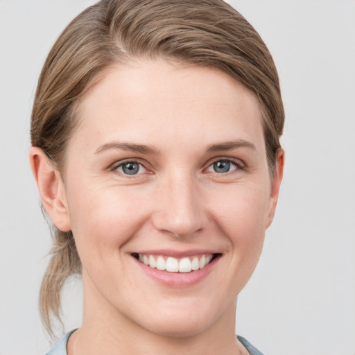 Joyful white young-adult female with short  brown hair and grey eyes