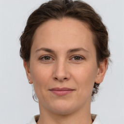 Joyful white adult female with short  brown hair and grey eyes