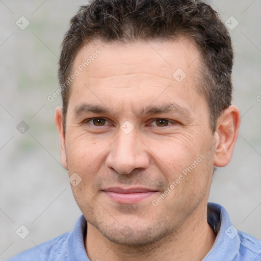 Joyful white adult male with short  brown hair and brown eyes