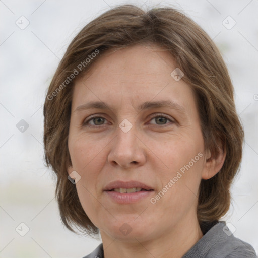 Joyful white adult female with medium  brown hair and grey eyes