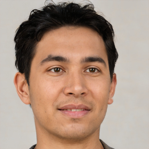Joyful white young-adult male with short  black hair and brown eyes