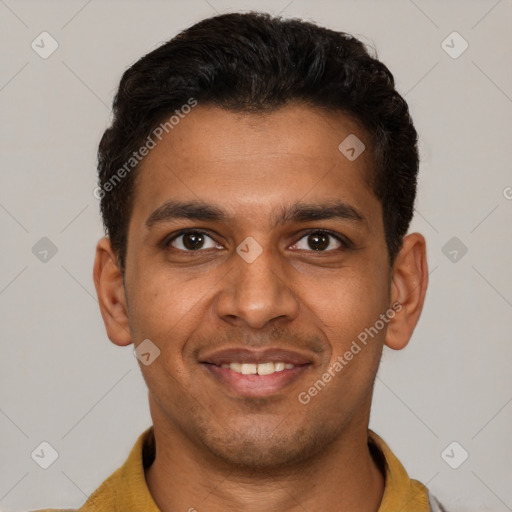 Joyful black young-adult male with short  brown hair and brown eyes