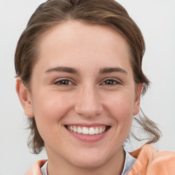 Joyful white young-adult female with medium  brown hair and grey eyes