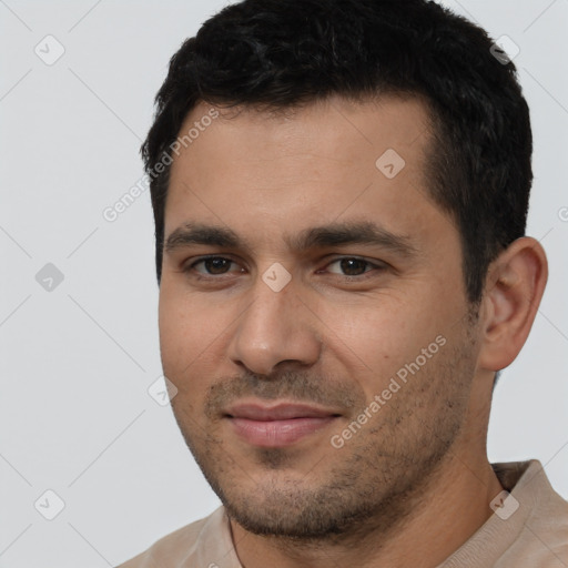 Joyful white young-adult male with short  black hair and brown eyes