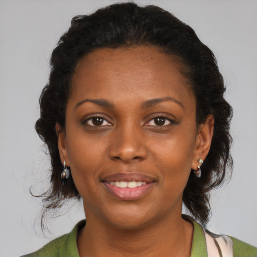 Joyful black young-adult female with medium  black hair and brown eyes