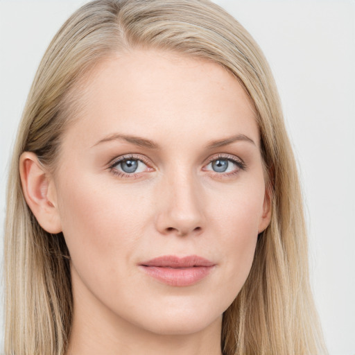 Joyful white young-adult female with long  brown hair and blue eyes