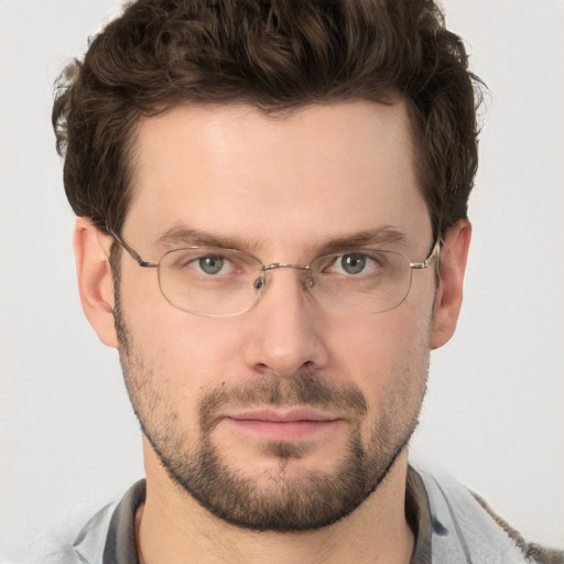 Joyful white adult male with short  brown hair and grey eyes