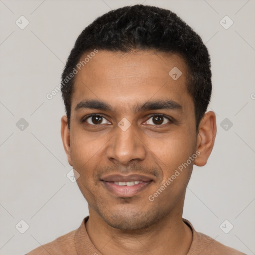 Joyful black young-adult male with short  black hair and brown eyes