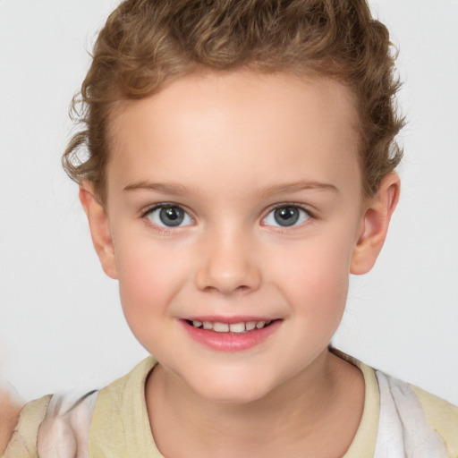 Joyful white child female with short  brown hair and blue eyes