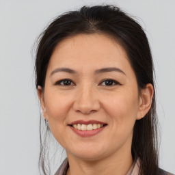 Joyful asian young-adult female with medium  brown hair and brown eyes