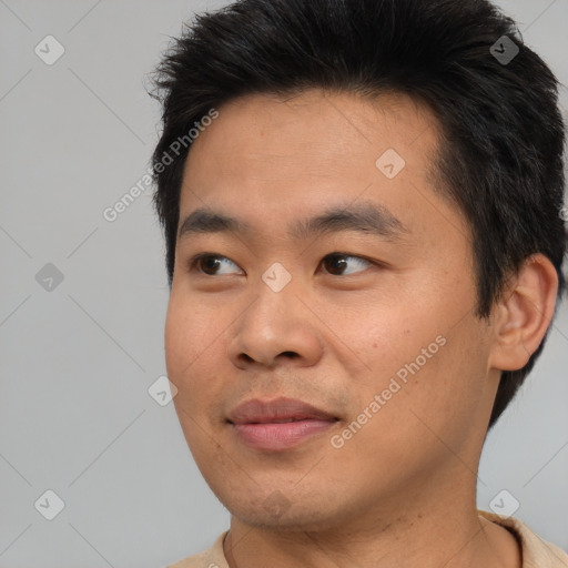 Joyful asian young-adult male with short  brown hair and brown eyes