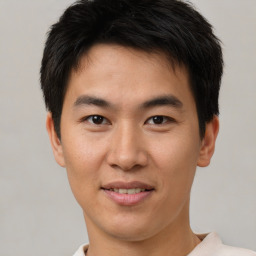 Joyful asian young-adult male with short  brown hair and brown eyes