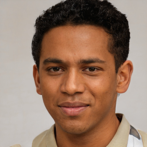 Joyful black young-adult male with short  black hair and brown eyes