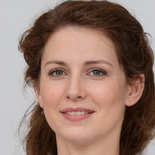 Joyful white young-adult female with long  brown hair and green eyes