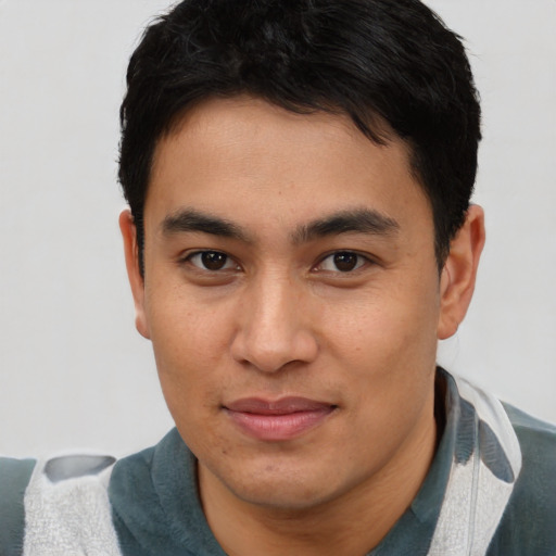 Joyful asian young-adult male with short  brown hair and brown eyes