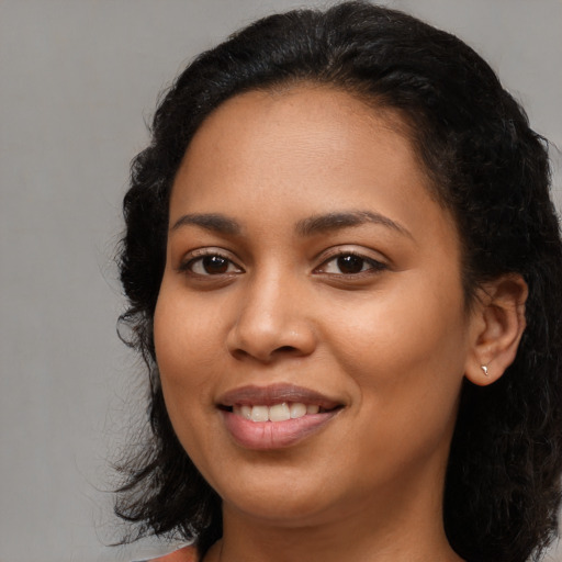 Joyful latino young-adult female with medium  black hair and brown eyes