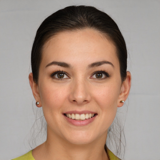 Joyful white young-adult female with medium  brown hair and brown eyes