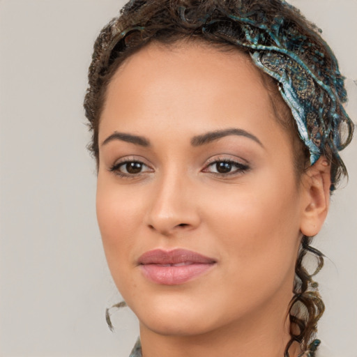 Joyful latino young-adult female with long  brown hair and brown eyes