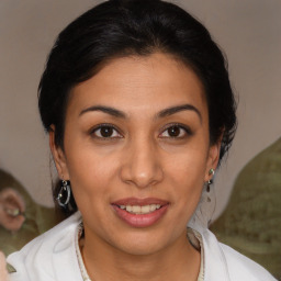 Joyful latino young-adult female with medium  brown hair and brown eyes