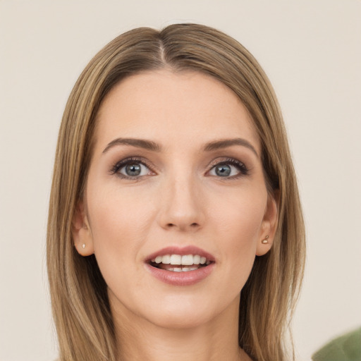 Joyful white young-adult female with long  brown hair and green eyes