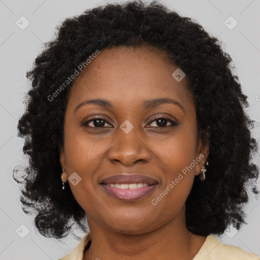 Joyful black adult female with medium  brown hair and brown eyes